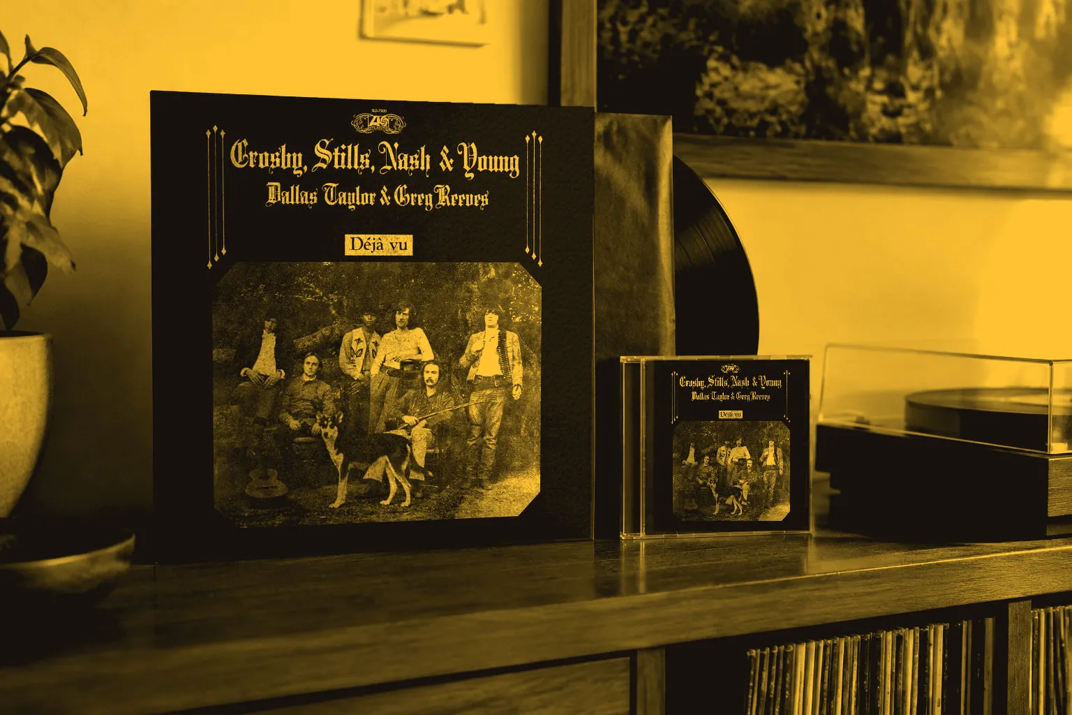 A copy of Déjà Vu on LP and CD standing on a wooden sideboard beside a turntable.